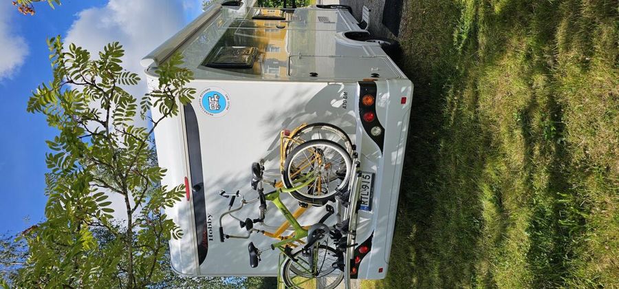 Matkailuauto ja sähköpyörät telineessä